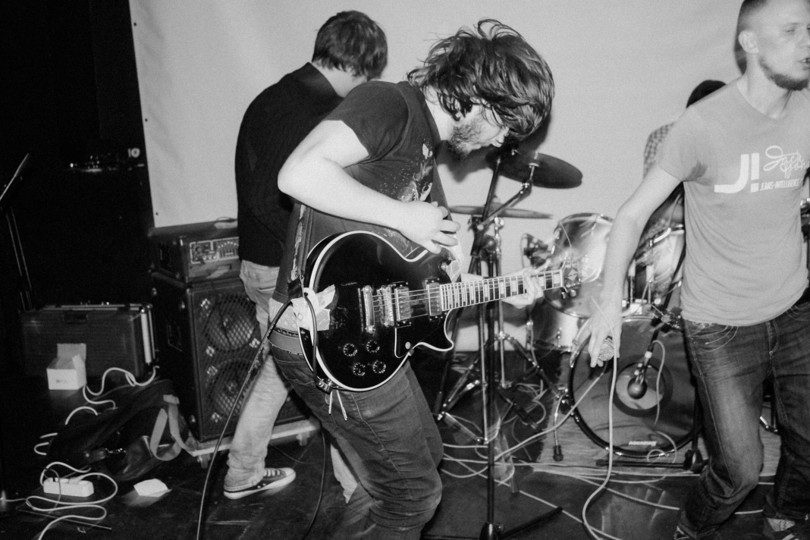 Musician playing guitar at a live session